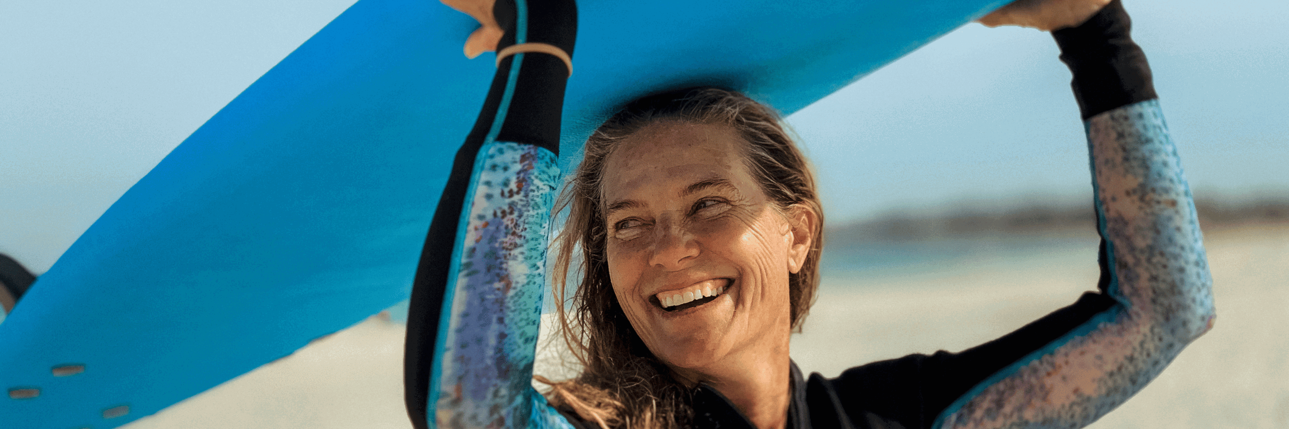 Woman surfer smiling with surfboard